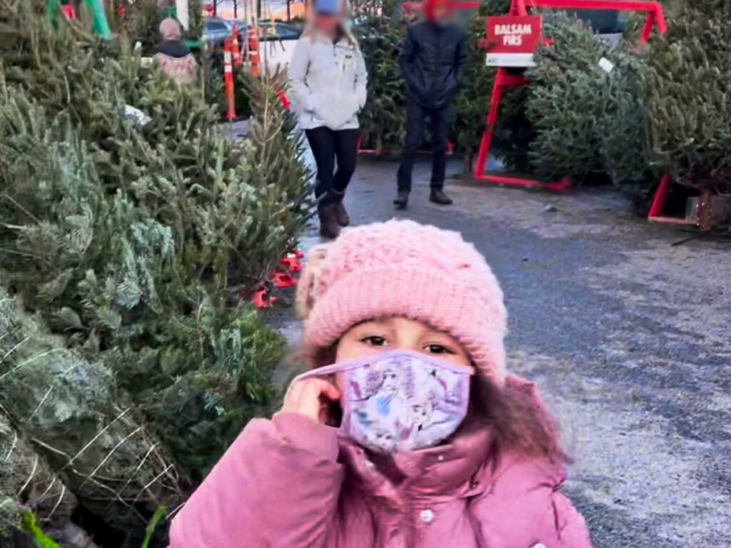 A child at the tree market at Snowport