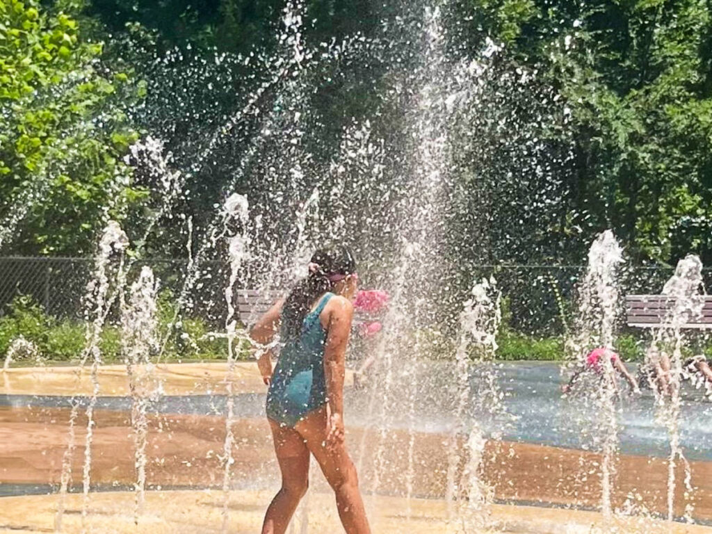 A child playing at the spray deck