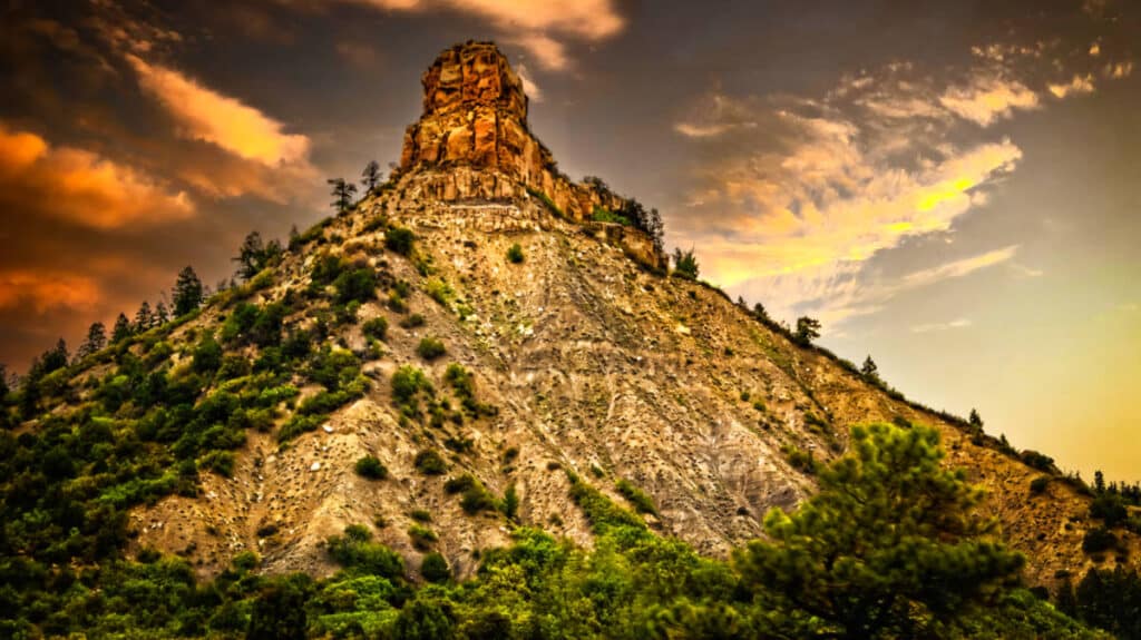 View of the peak of unique rock formation in Chimney Rock National Monument at sunset