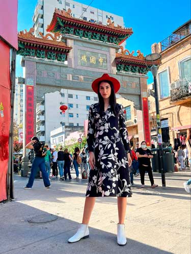 Clara posing for a photo under the clear blue sky in Chinatown Buenos Aires