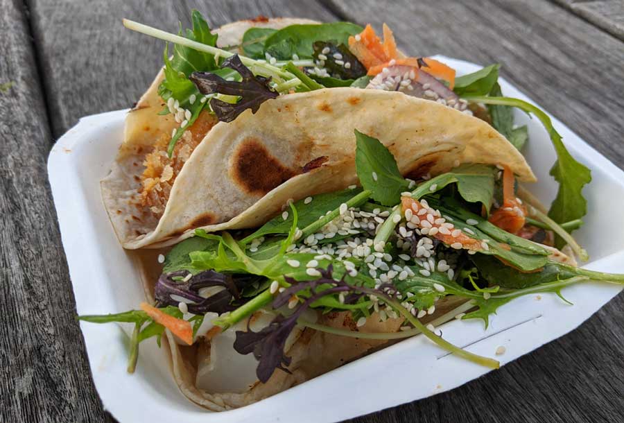 A tacos filled with vegetable in Chino Bandido