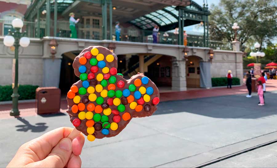 The author holding a Mickey Mouse shaped chocolate