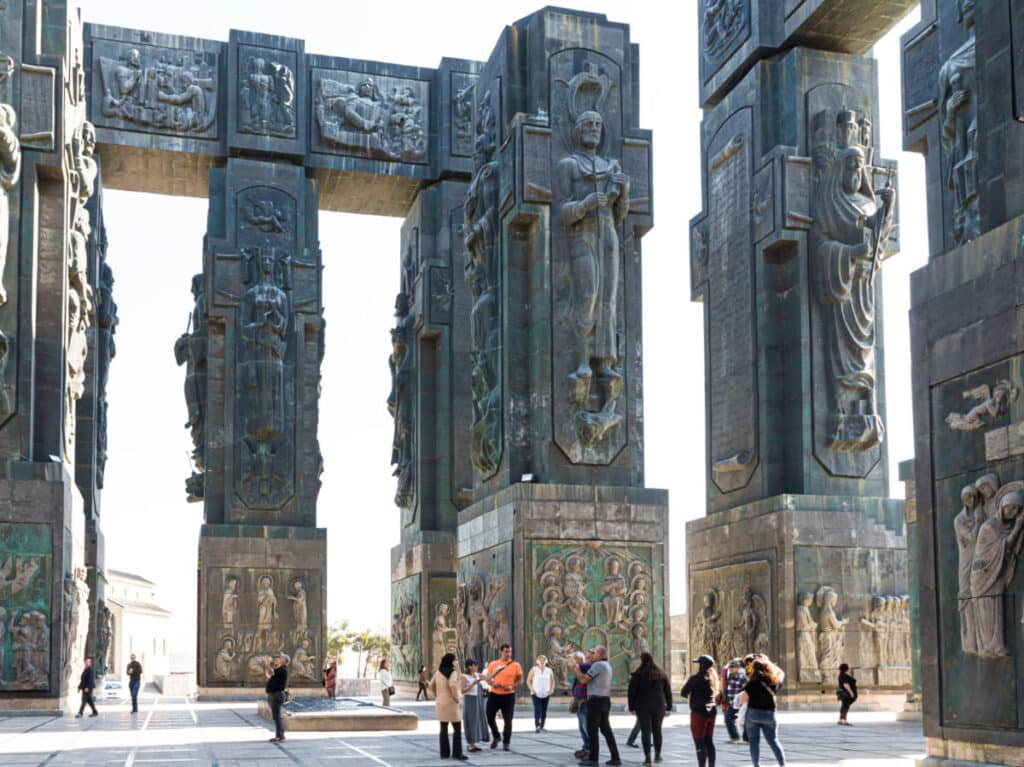 View of the people wandering around the huge intricate columns at the Chronicle of Georgia