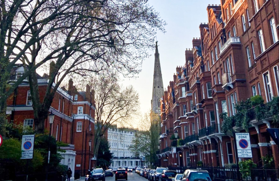 View of the church tower from the red brick street in London