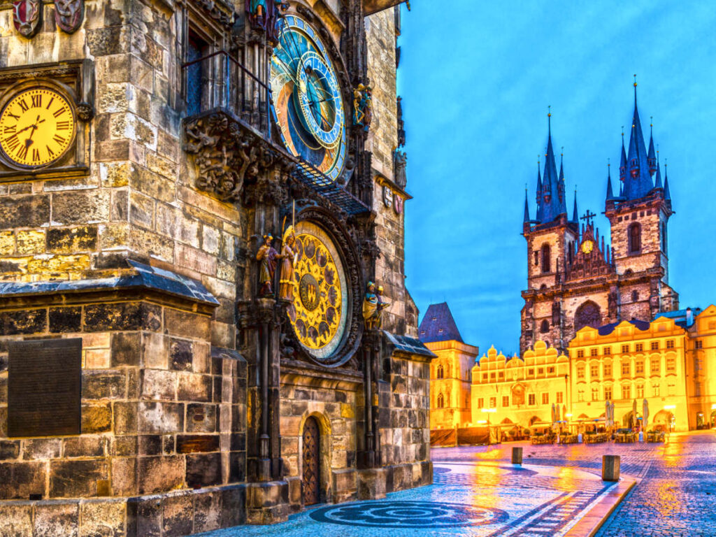 View of the illuminated Tyn Church and Old Town Square at night