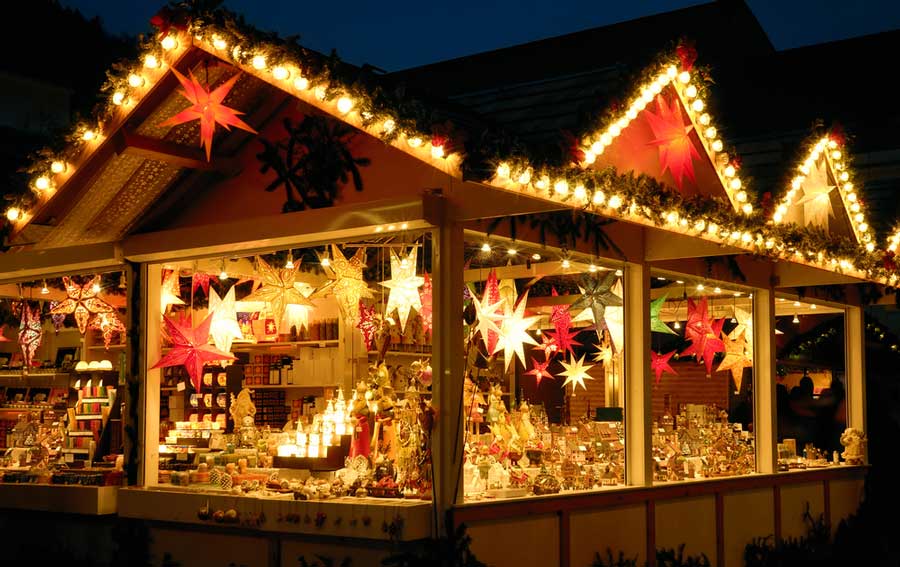 View of a store filled with lights at night during the Cincinnati Christkindlmarkt