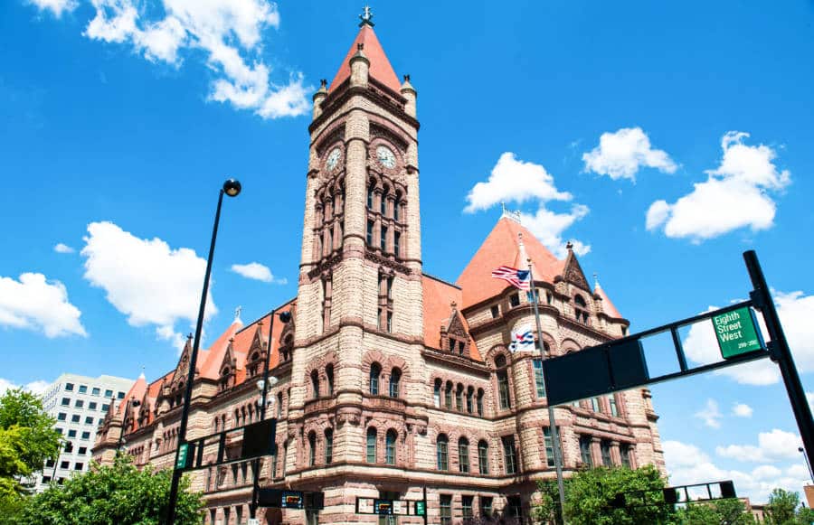 View of the Cincinnati City Hall from below with a blue and cloudy sky in the background