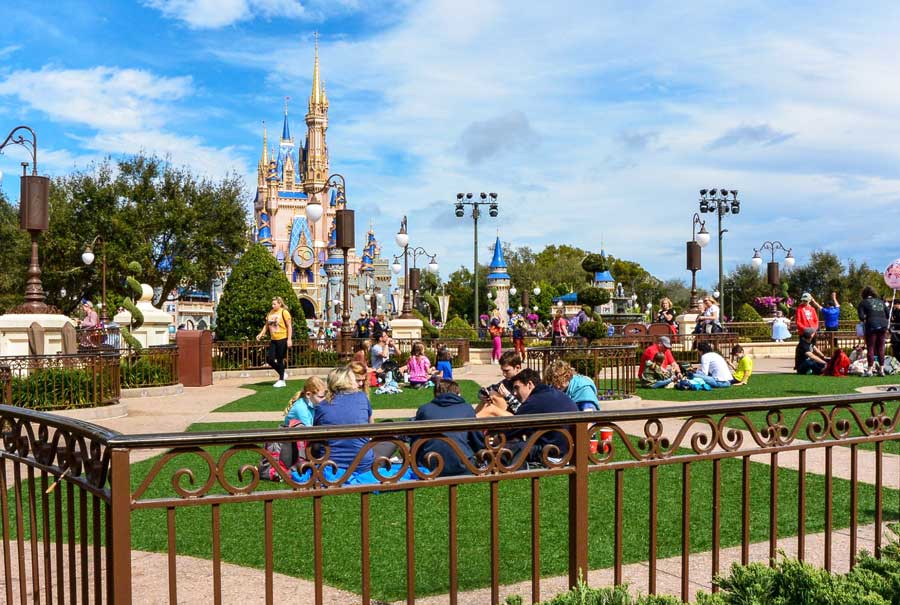 People enjoying their day at the hub in front of the Cinderella Castle