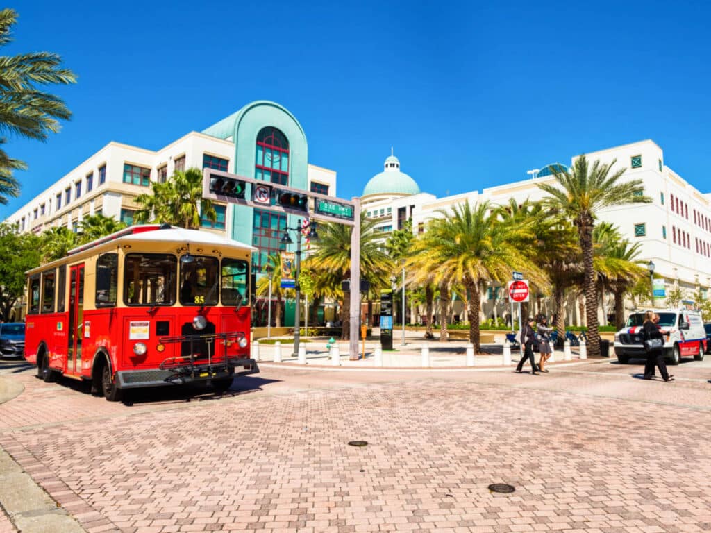 View of the City Hall and a red tram at Downtown West Palm Beach