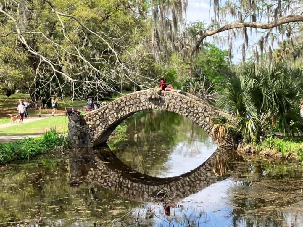A woman sitting on a bridge at the City Park in Bayou St. John