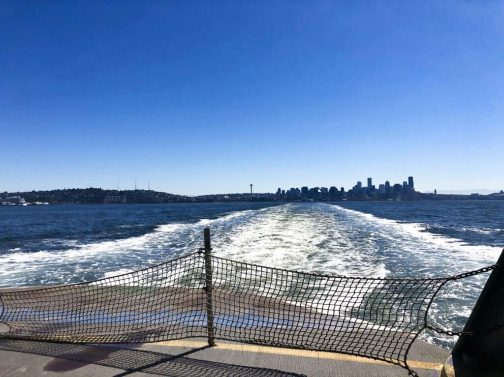 View of the city skyline from the back of the ferry on a sunny day