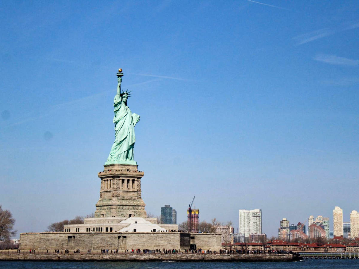 Panoramic view of the city skyline behind the Statue of Liberty