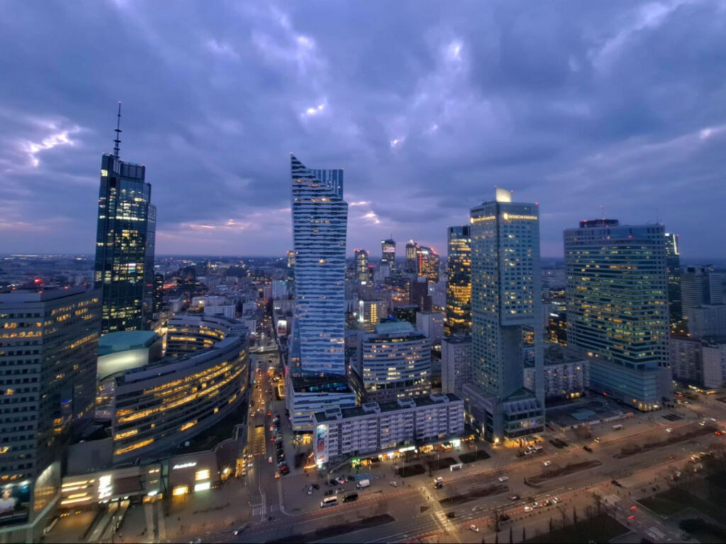 City skyline and tall buildings in Warsaw at dusk