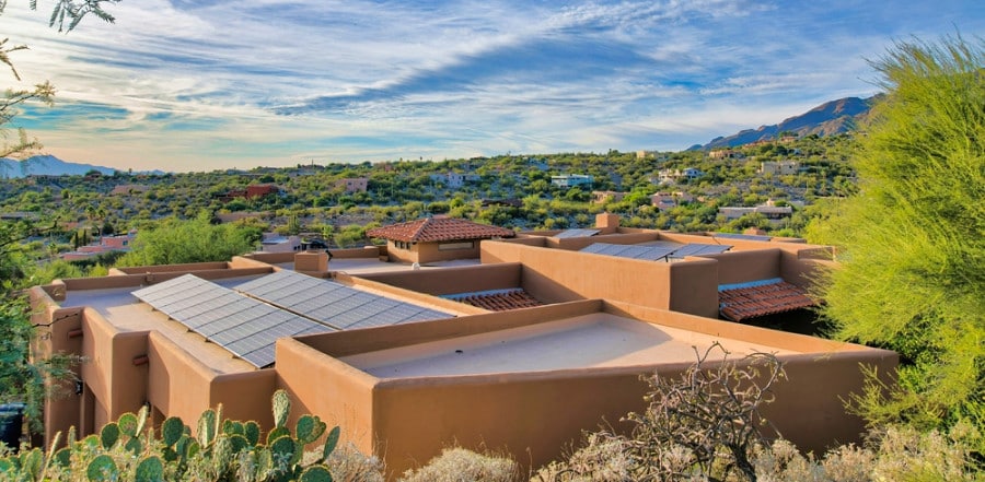 Aerial view of a Mediterranean house with solar panels and clay tile roofs at Tucson