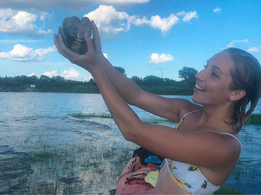 The author holding the clams that she collected in Long Island