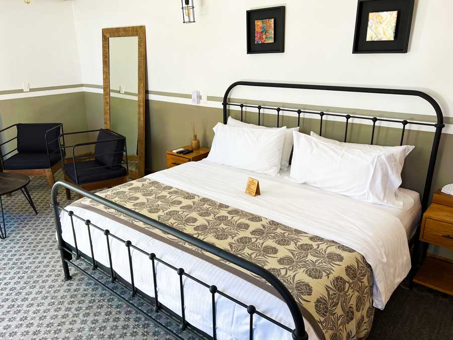 View of a bed and a big mirror in Clandestino Hotel Pila Seca