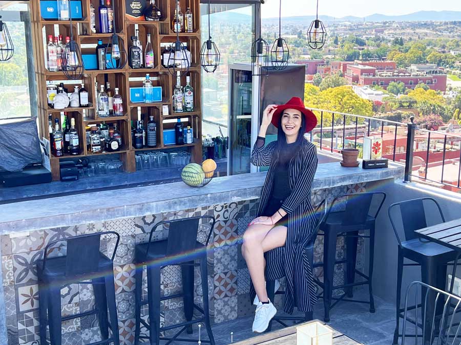 Clara on a bar stool in a rooftop bar in Clandestino Hotel Recreo