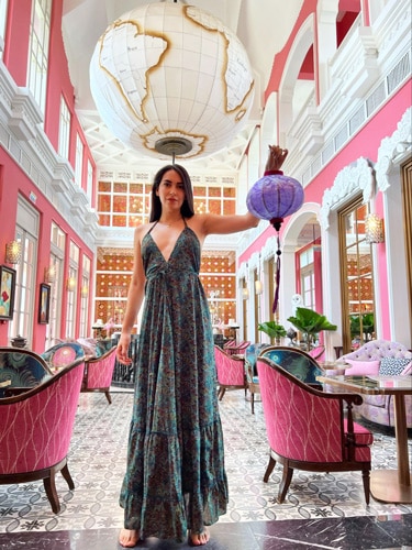 Clara posing for a photo while holding a lantern in Pink Pearl