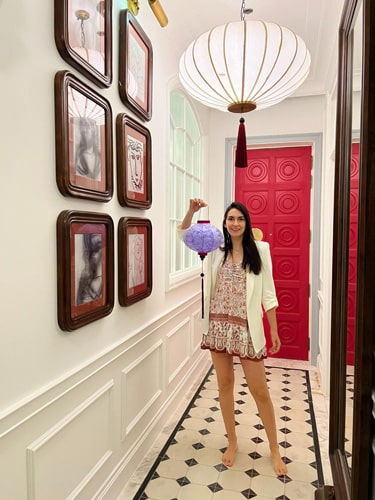 Clara holding a lantern while on the hallway of their room