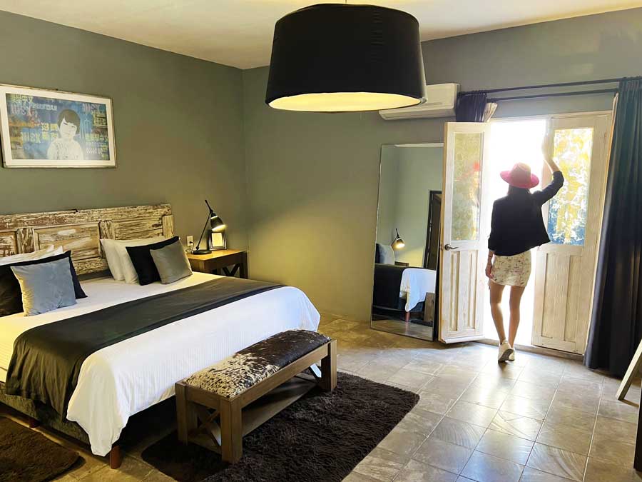 Clara standing by the door bedroom in Nena Hotel Boutique