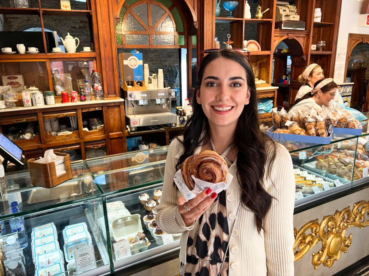 Travel Lemming Writer, Clara, holding a sugary treat at Dulcería Manu Jara