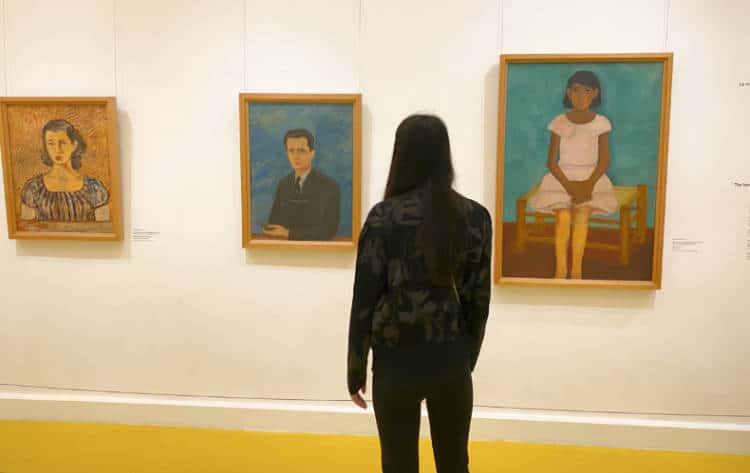 Travel Lemming writer Clara viewing paintings at the Frida Kahlo Museum