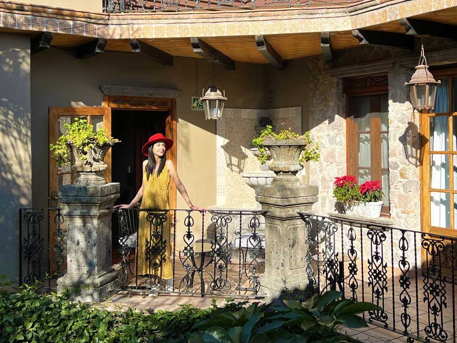 Clara standing on a balcony in Hotel Mansion