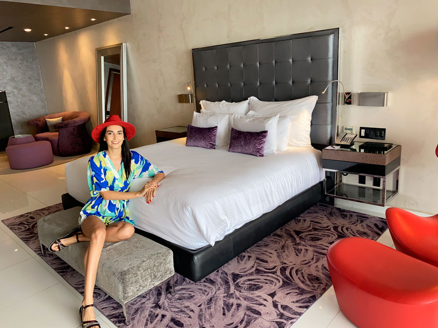 Clara sitting on a bed in a room in Hotel Mousai