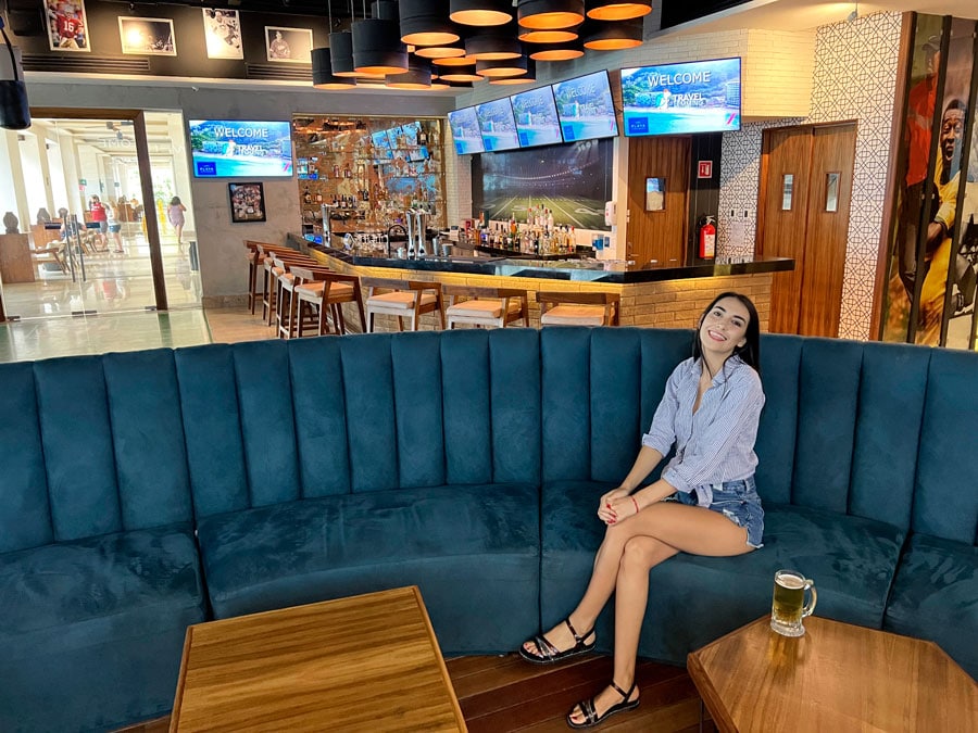 Clara sitting on a couch in a bar in Hyatt Ziva