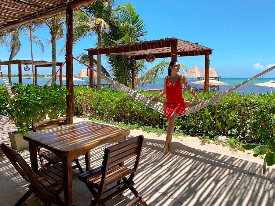 Clara on a hammock with a beach view at the Mereva Tulum