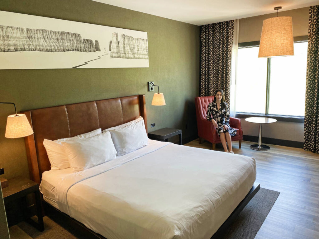 Clara Kesseler sitting on a chair inside their room in Origin Hotel Red Rocks