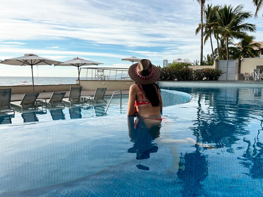 Clara admiring the view while on the pool in Sunset Plaza Beach Resort
