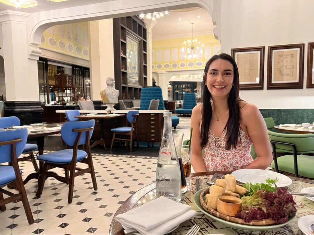 Clara smiling for a photo during their dinner in Tempus Fugit