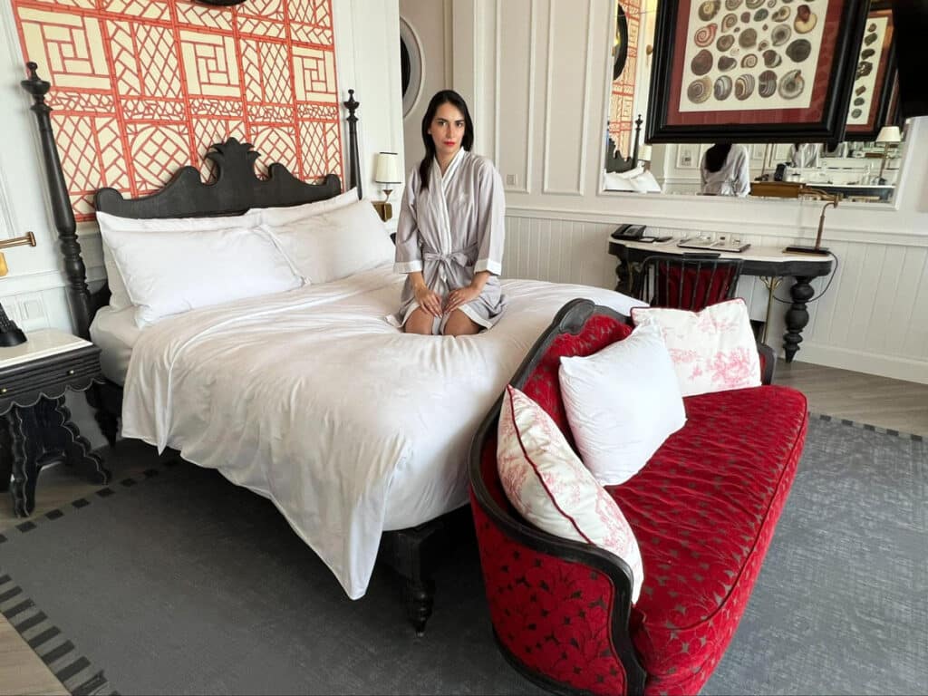 Clara sitting on their bed at their room in The Department of Conchology
