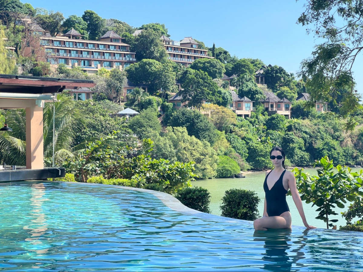 The author's partner, Clara on the infinite pool surrounded by greenery at The Westin Siray Bay