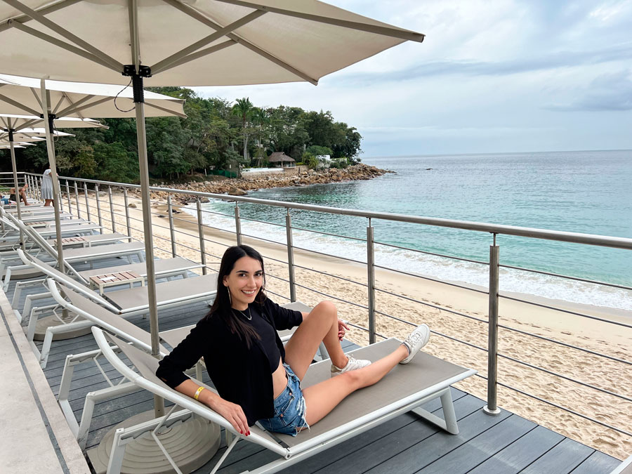Clara sitting on a beach chair with the ocean view