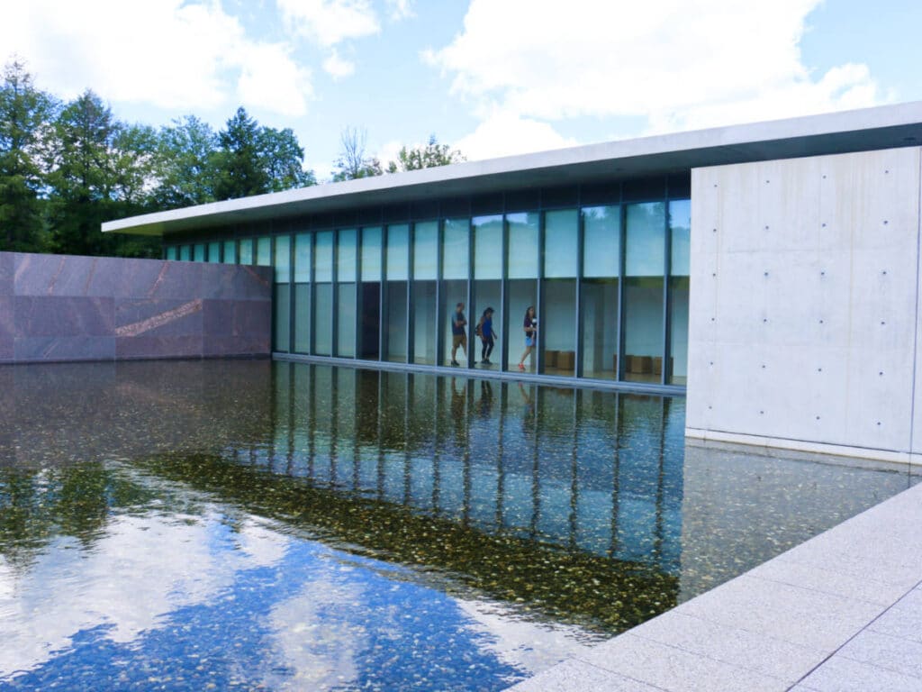 View of the glass windows and exterior of Clark Art Institute reflecting on the pool