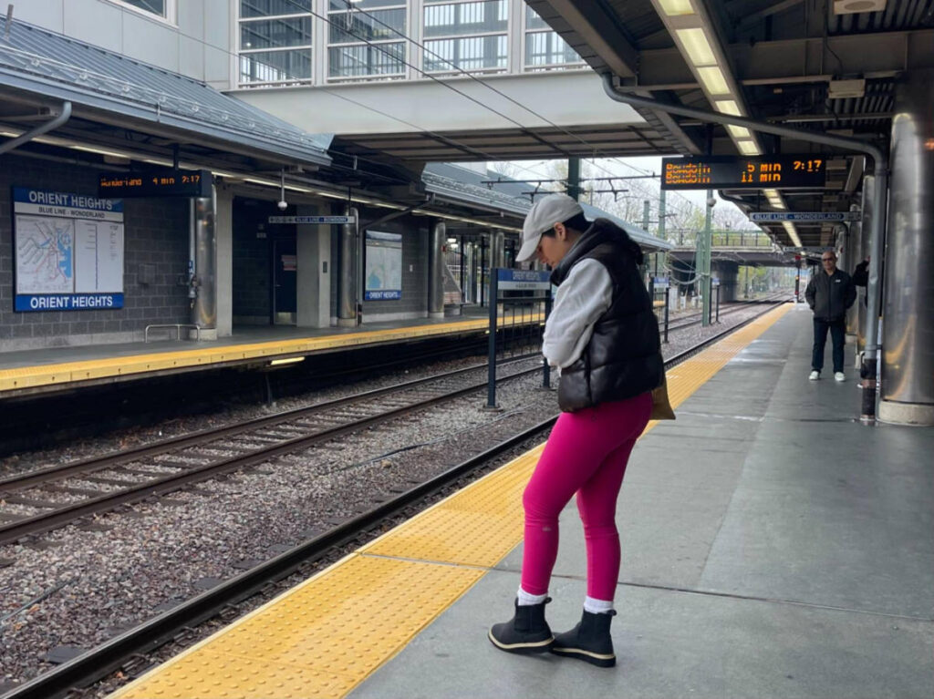 The author Claudicet Pena dressed in layers at the train station