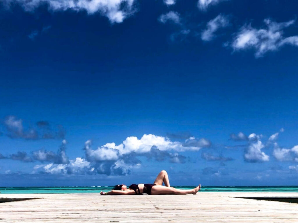 The author Claudicet Peña relaxing on a dock in Punta Cana