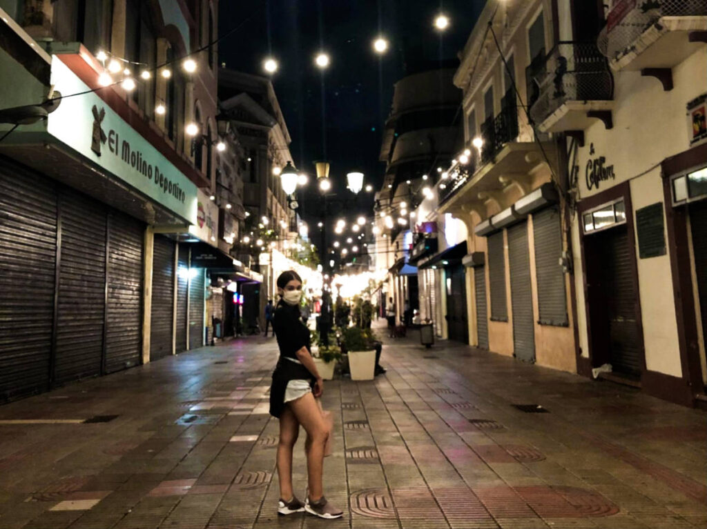 The author Claudicet Peña posing for a photo at Calle Conde at night