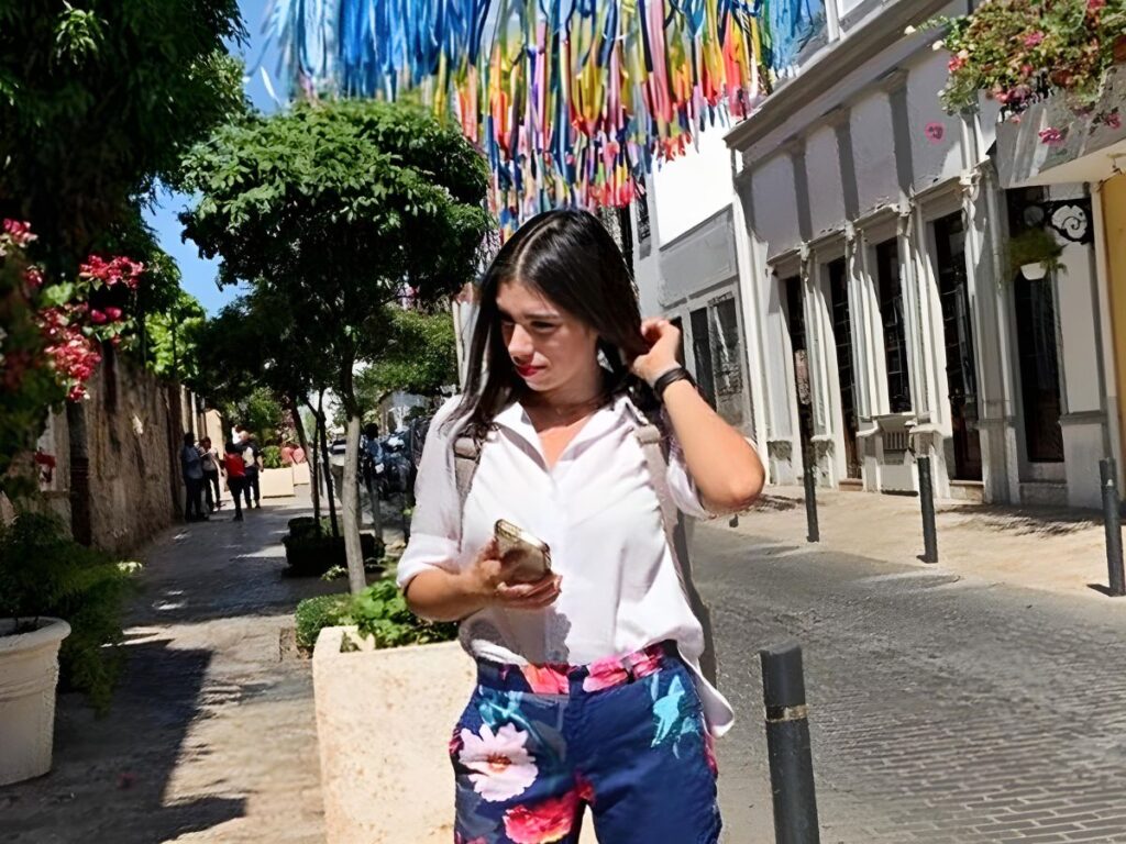 The author Claudicet Peña posing for a photo at the streets of Zona Colonial