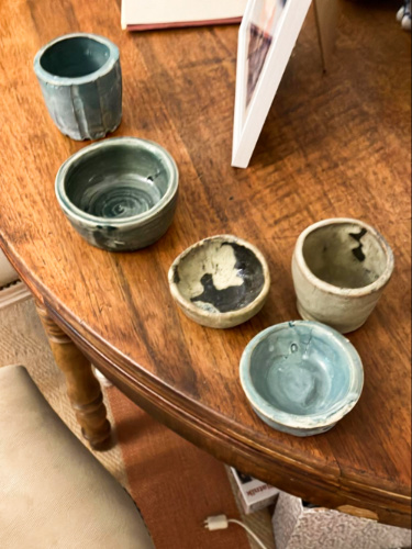 The author's clay pots on the wooden table