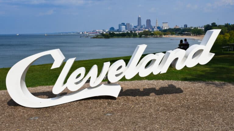 View of the "Cleveland" signage and skyline at Lake Erie Edgewater Park, one of the best beaches in Cleveland