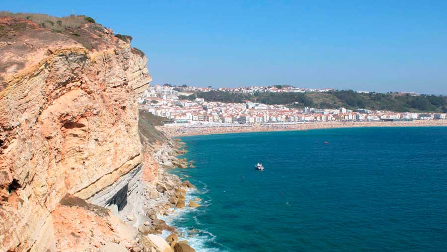 View of a cliffed coast under the clear blue sky
