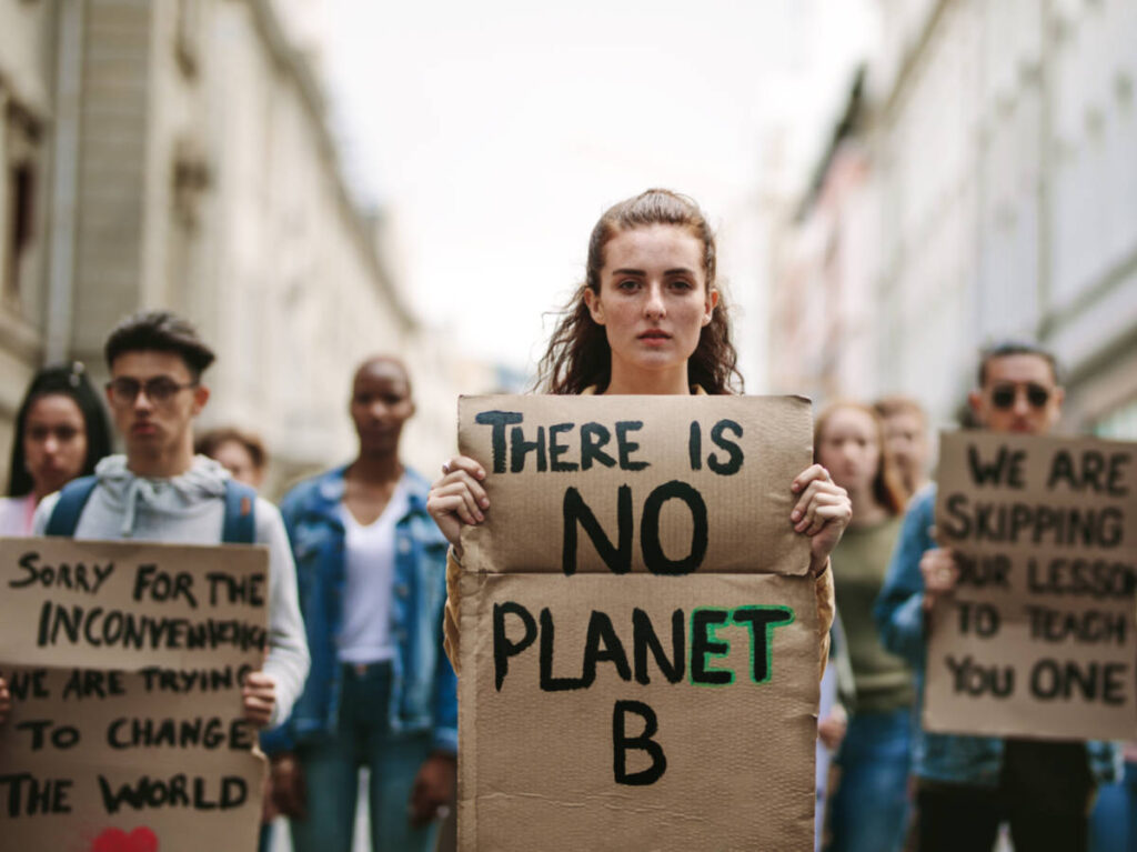 A group of students protesting about climate change in the middle of the street