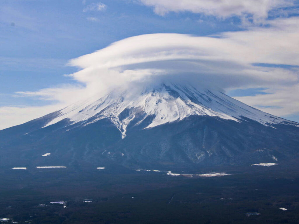 Closeup look of the Mount Fuji with the clouds hovering above