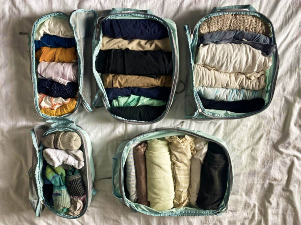 View of the clothes inside the unzipped packing cubes
