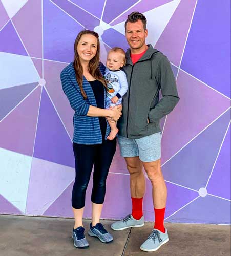 The with her husband and son with a colorful background