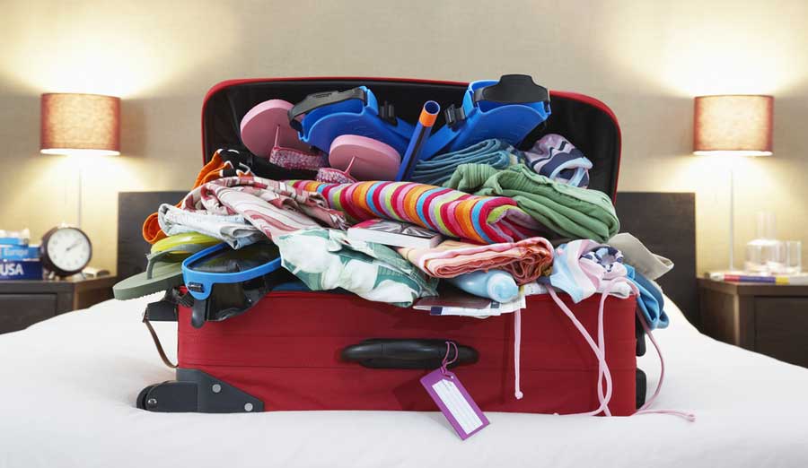 An open suitcase full of clothes and things