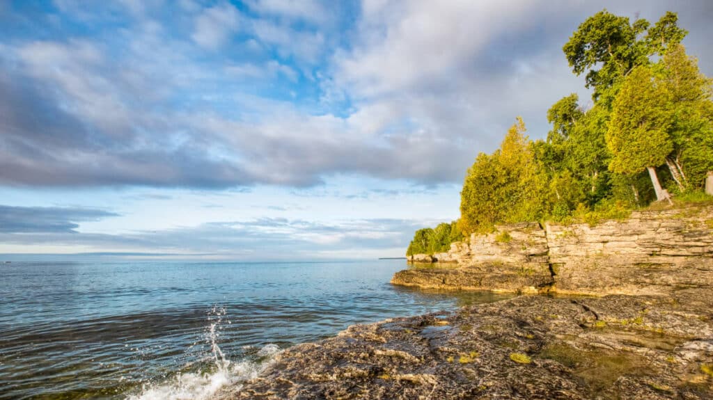 Small waves hitting the rocky coastline in Door County